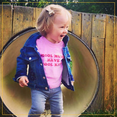 girl in a cool mums have cool kids baby pink t-shirt